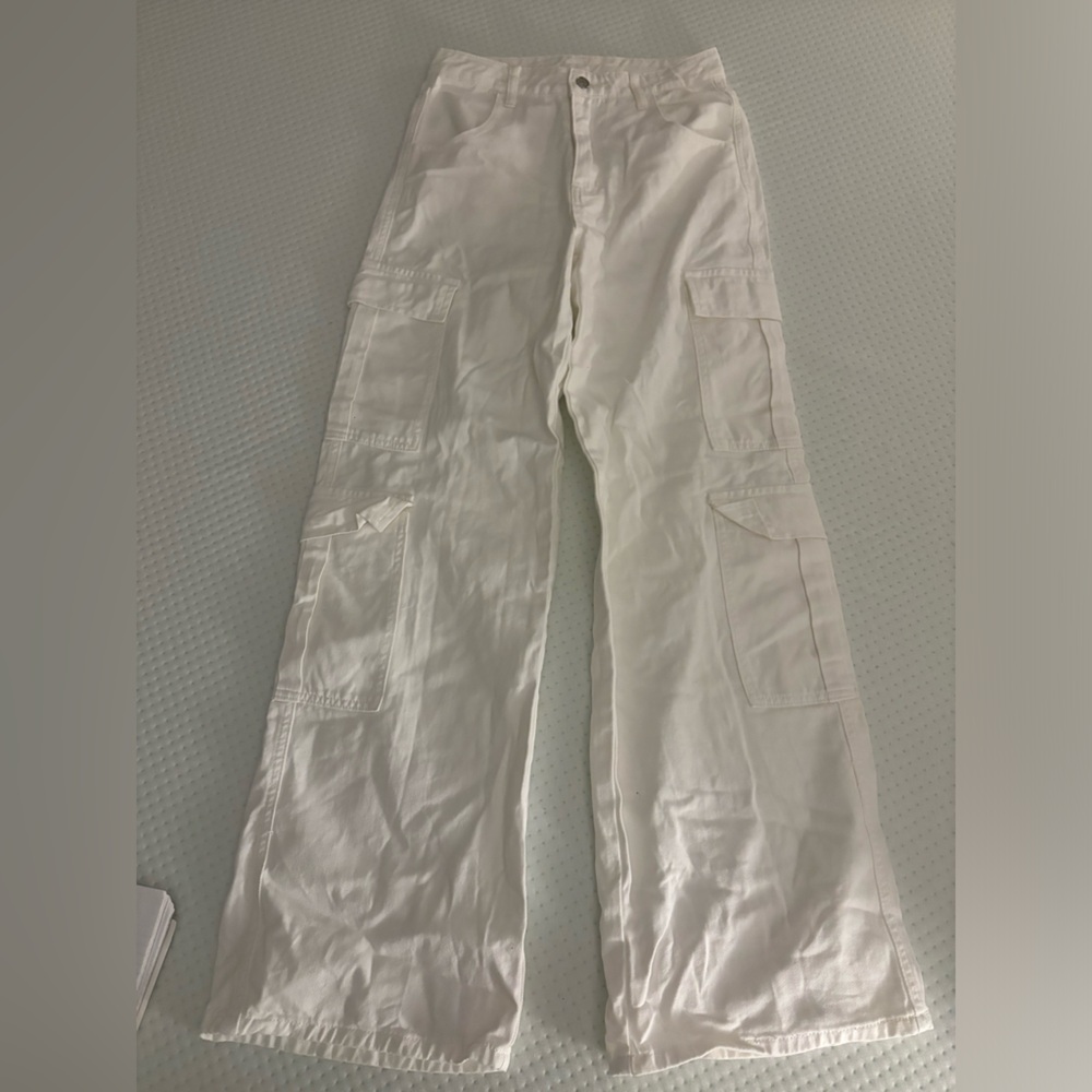 White flared cargo pants with many pockets